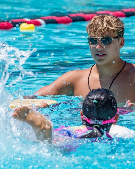 Tommy teaching a young swimmer in the pool